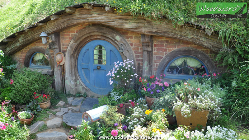 Hobbit house with a blue door - Hobbiton Movie Set Sign New Zealand - Woodward Culture Travel Guide