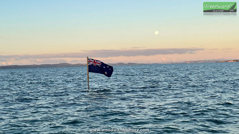 New Zealand Flag in the water at Eastern Beach in Auckland, New Zealand - Woodward Culture Travel Guide