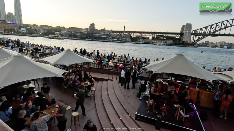 Band playing at a bar near Sydney Opera House with views of the Sydney Harbour Bridge in Australia - Woodward Culture